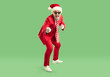 © Studio Romantic - Full length shot of emotional fashionable Santa Claus in elegant red suit having fun and indicating at you, exclaiming loudly, choosing you to participate in New Year Party celebration.