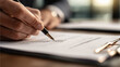 © Enrique - a person signing a document with a pen, close-up of hands and paper, professional setting, office desk with documents and clipboard