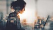 © AB Design - Woman working on a laptop double exposed with a cityscape