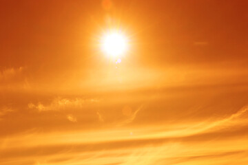 Wall Mural - orange sky with sun and clouds during hot summer weather. extremely high temperature