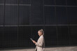 © Westend61 - Smiling businesswoman using tablet PC by solar panels
