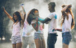 © oneinchpunch - Group of teens playing with colors at the holi festival, in a park