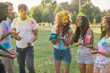 © oneinchpunch - Group of teens playing with colors at the holi festival, in a park