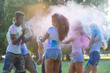 © oneinchpunch - Group of teens playing with colors at the holi festival, in a park