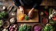 © Attasit - Top-down view of chef hands slicing vegetables, food prep and skill, space for campaign copy