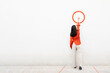 © VISTA by Westend61 - Woman in orange shirt writing on a white wall with a circle illustration