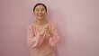 © Krakenimages.com - Woman smiling against a pink background, showcasing a cheerful expression, wearing a pink blouse, highlighting modern fashion with simplicity and elegance, exuding joy and warmth.