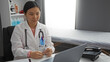 © Krakenimages.com - Female doctor working in a hospital office with a stethoscope and laptop in a clinic room, concentrating on healthcare tasks in an organized medical setting indoors in china.