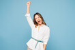 © ViDi Studio - Young happy fun employee business woman corporate lawyer wear shirt classic formal clothes work in office do winner gesture celebrate clenching fists isolated on light blue background studio portrait.