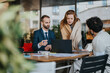 © qunica.com - Business professionals collaborating outdoors at a cafe table for a meeting, discussing ideas. Creative setting with a casual yet professional atmosphere, fostering teamwork and discourse.