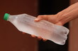© Oualid - Hand holding a bottle of frozen water