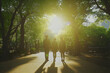 © NAJLA - Silhouetted friends walking in sunlight path summer nature scene