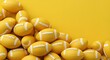 © STDG - American football, Football, Pigskin, Pile of Yellow American Footballs on Yellow Background