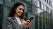 © STDG - Woman, Businesswoman, Professional, Smiling Businesswoman Using Smartphone in City