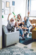 © BullRun - Cozy living room with friends eating pizza taking selfie on smartphone