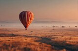 Hot air balloon flying over maasai mara national reserve during sunrise