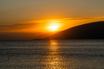Wall Mural - Beautiful sunset with clouds over the lake.