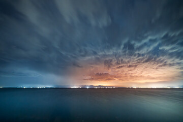 Wall Mural - Beautiful night landscape, long exposure clouds over the lake. Starry night. 