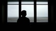 © Olena - Silhouette looking out window at bleak and desolate landscape
