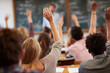 © mattegg - Students actively raising hands in class engaged students learning