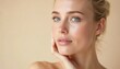 © Vadym - Beautiful young blonde woman with clean fresh skin. Model with healthy skin, blue eyes close up portrait on beige background. Cosmetology beauty spa facial therapy.