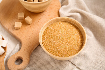 Wall Mural - Bowl with brown cane sugar on table
