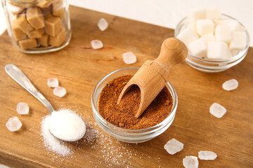 Wall Mural - Wooden board with different types of sugar on white background