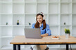 © David - Beautiful young Asian woman college student wearing white headphones at classroom. College student working on the college campus. back to school concept