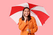 © Pixel-Shot - Happy young woman with umbrella on pink background