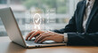 © Tiago - Person typing on laptop with quality assurance graphic overlay showing compliance and standards check