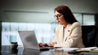 © Andrey Popov - Female CEO Boosts Productivity With Laptop
