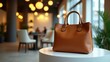 © Ylstudiobd - Brown leather tote bag in modern cafe setting