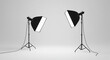 © MdBellal - Two professional photography studio lights with softboxes are set up on tripods against a white background