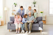 © Studio Romantic - Happy big family portrait, three generation people gathering watching photo album, grandparents, adult children, kids, spending time at home together to remember live moments, share good emotions