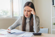 © Pormezz - Financial owe, hand of asian woman sitting, holding credit card, stressed by calculate expense from invoice or bill, no money to pay, mortgage or loan