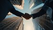 © Attasit - Successful business deal captured from a low-angle perspective in a financial district.