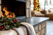 © ธีรเชษฐ์ ชิณวงศ์ - Cozy winter scene featuring fireplace adorned with festive wreath and soft blanket, creating warm atmosphere