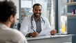 © Steven - Black Male Doctor Consulting Patient Paperwork Healthcare