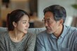 © Sameera - Family problems. Asian couple quarrelling together at home. Woman angry at man, and man feeling annoyed., Generative AI