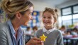 © AndiAzis - A teacher rewards a smiling student with a star-shaped treat in a bright classroom.