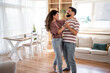 © Migma_Agency - Happy couple dancing together in their modern living room