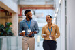 © Drazen - Cheerful black coworkers talking while having coffee break in office.