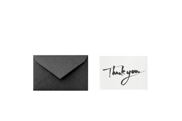 Wall Mural - a cutout of a black glittery envelope with a black text handwritten thank you message card, overhead