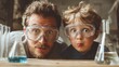 © inspiretta - Dad and a son wearing goggles are looking at a beaker