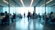 © ShazilStock - Blurred Office Scene Modern Workspace with People Working and Walking Creating an Atmospheric and Energetic Vibe