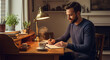 © Alvaro - Man writing journal while enjoying tea at cozy desk, evening self care routine.