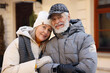 © New Africa - Family portrait of happy elderly couple on city street