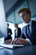 © Mselected - Professional young man working at computer in modern office during business hours