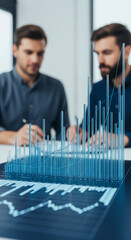 Wall Mural - blue transparent bar and line graph on dark background, two blurred businessmen in the background, s