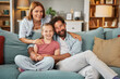 © Stockphotodirectors - A family of three relaxes on a comfortable sofa, sharing laughter and joyful moments in their cozy living room. The atmosphere is warm, inviting, and filled with love.